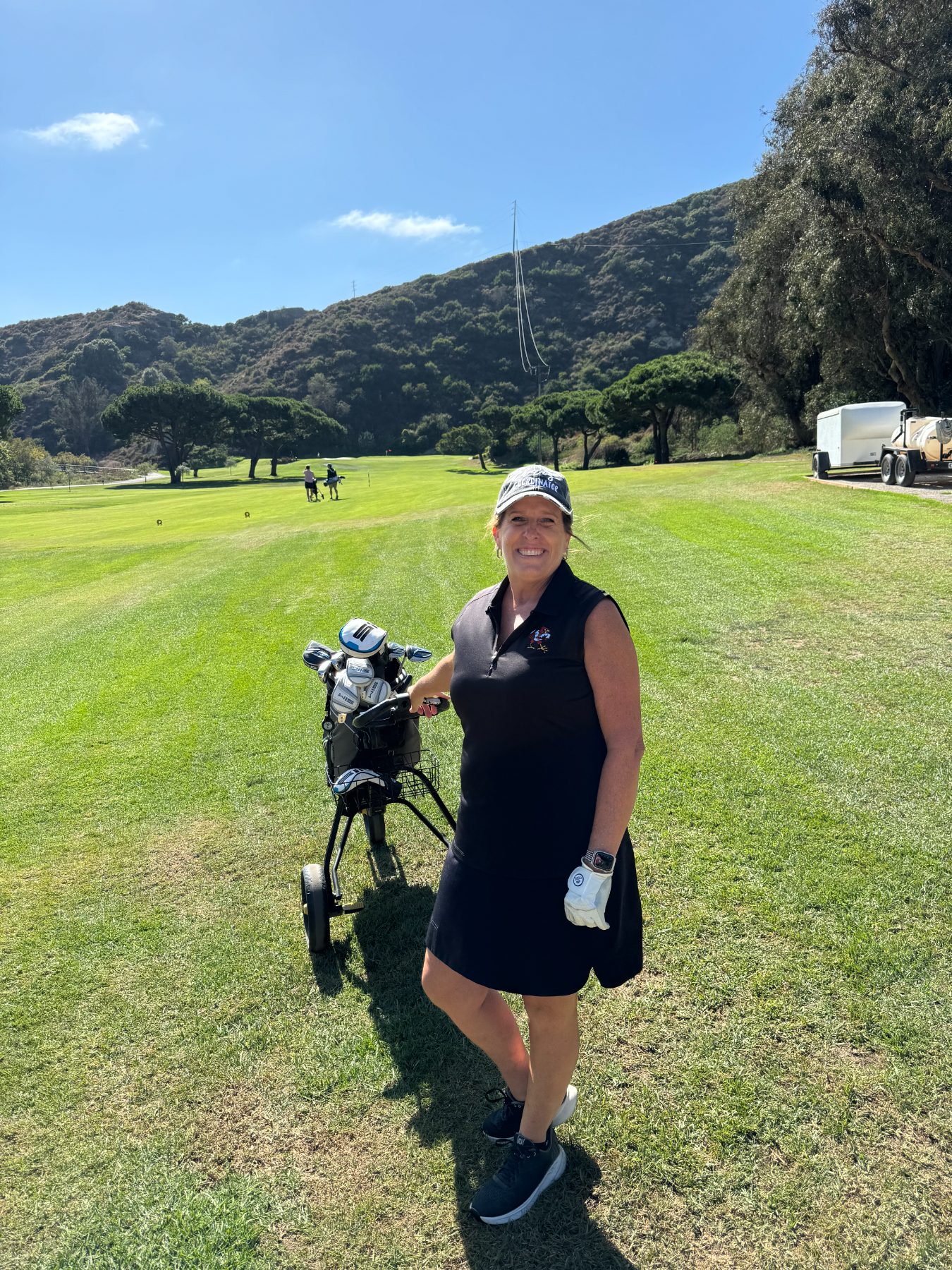 Push cart, black dress, canyon walls. This is the whole idea.
